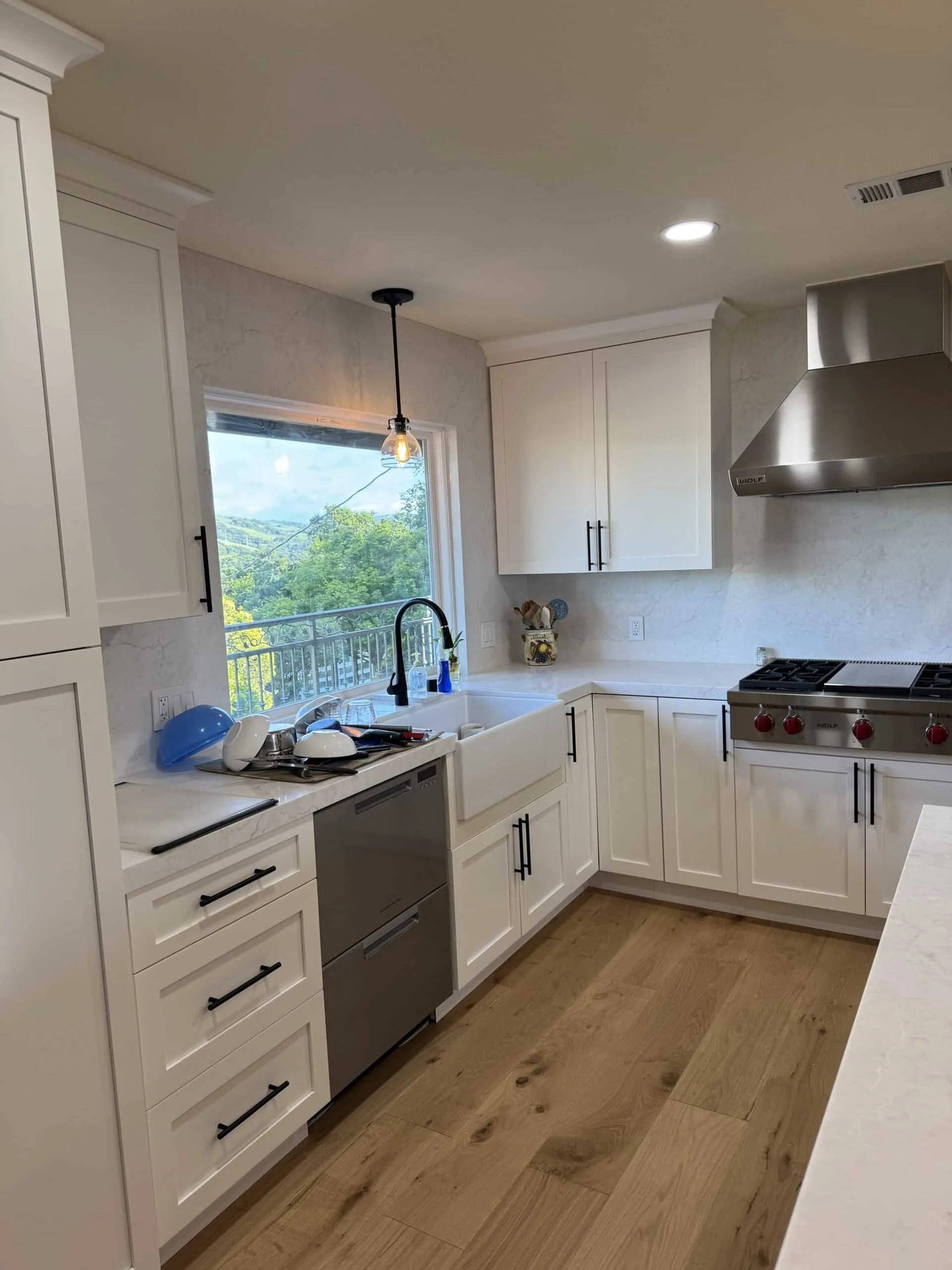 Custom white cabinetry, quartz countertops, and Wolf range in Topanga Canyon kitchen remodel.