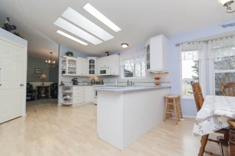 Modern kitchen remodel design with skylights and breakfast bar in Los Angeles