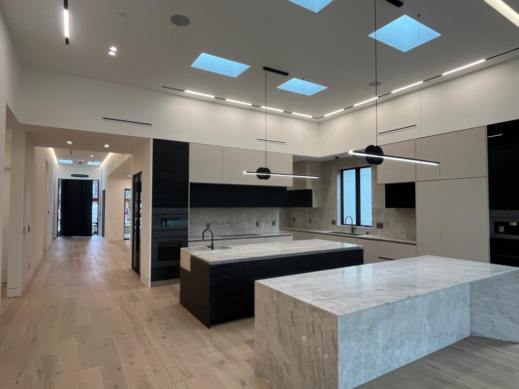 Modern organic kitchen with natural oak cabinetry and sage green island, Los Angeles remodeling project by Denali Builders & Design.