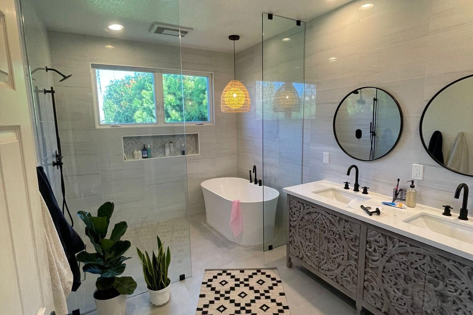 Newly remodeled bathroom with glass shower enclosure, double vanity, and modern fixtures in Los Angeles.