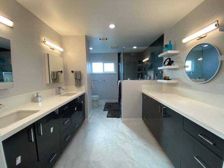 Los Angeles master bathroom remodel with floating double vanity and black tile walk-in shower.