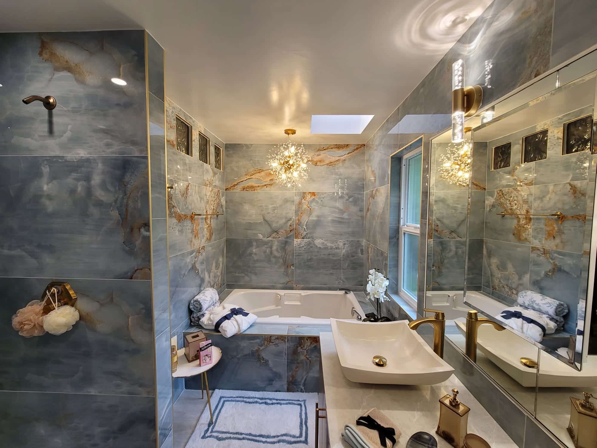 Luxury marble bathroom with a freestanding tub, double vanity, and glass shower