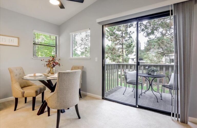 Brightly lit dining area showcasing a remodeled kitchen and dining space by Denali Builders &