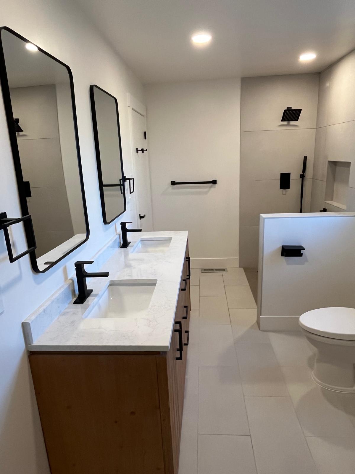 Bel Air bathroom remodel featuring a curbless walk-in shower, wood double vanity with white quartz
