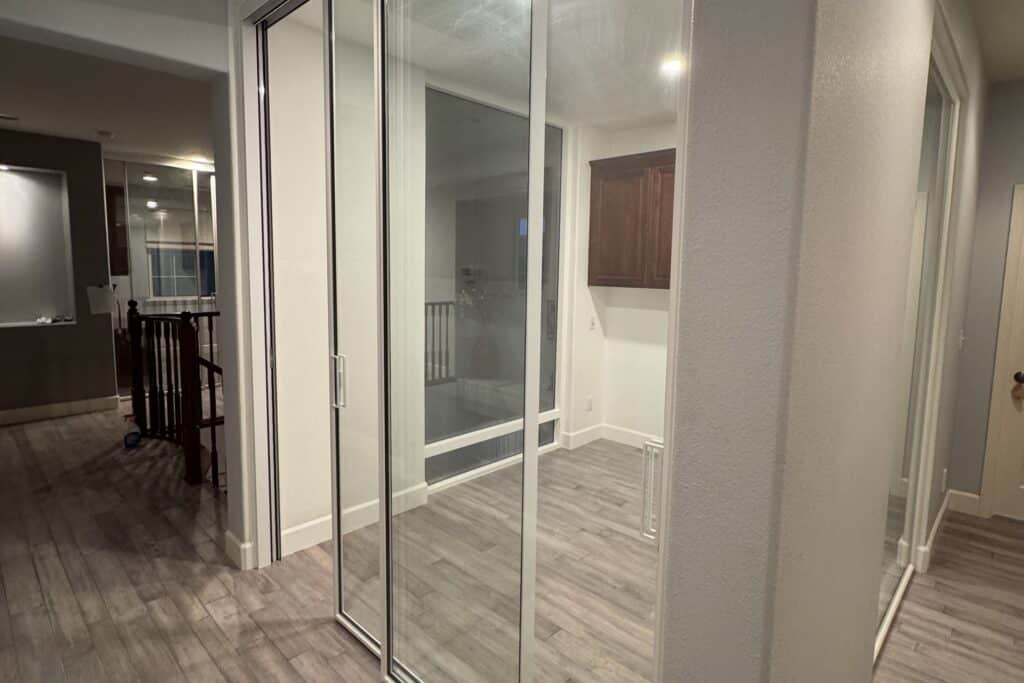 Large glass interior door with a frame creating an open and spacious connection between rooms