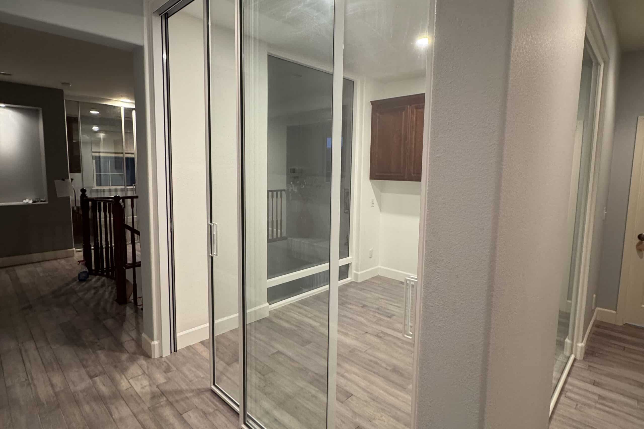 Large glass interior door with a frame creating an open and spacious connection between rooms