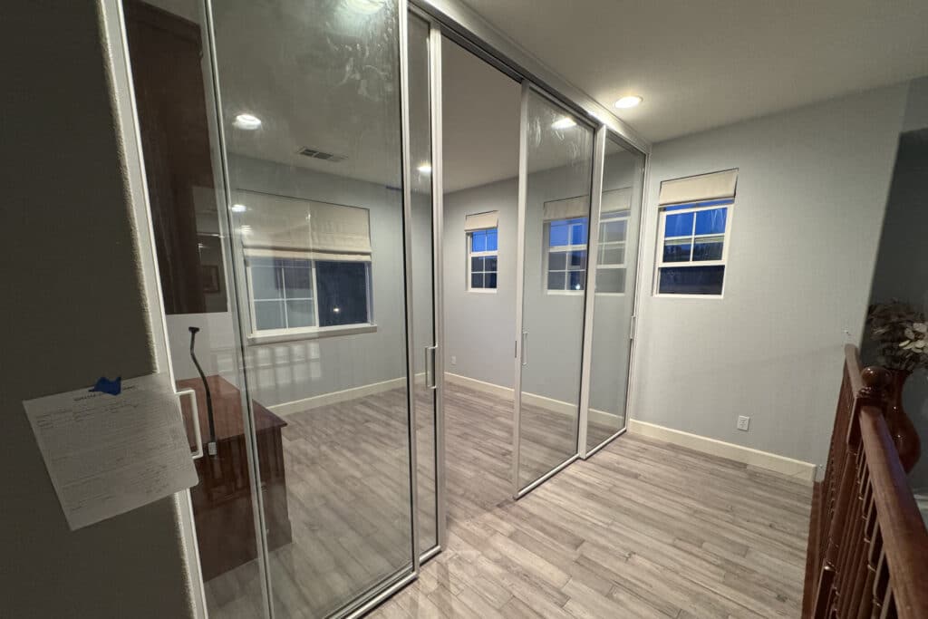 Elegant glass doors installed inside a modern home, allowing natural light to flow between interior spaces