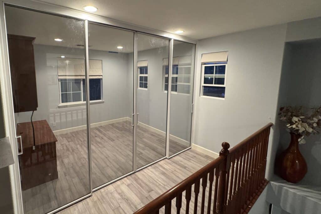 Modern interior glass door with a sleek frame separating two rooms in a bright contemporary home