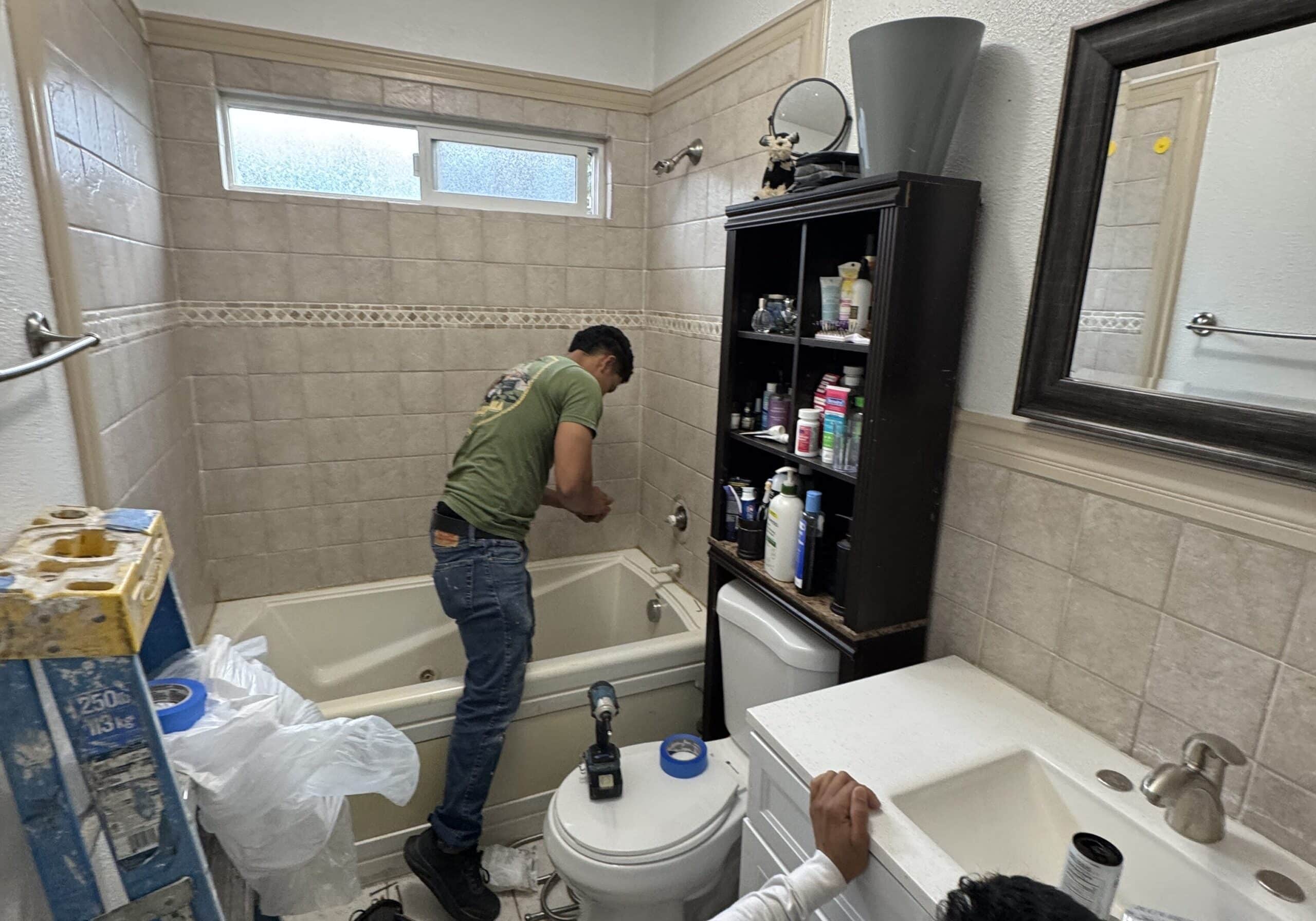 Two men working on a bathroom remodeling project